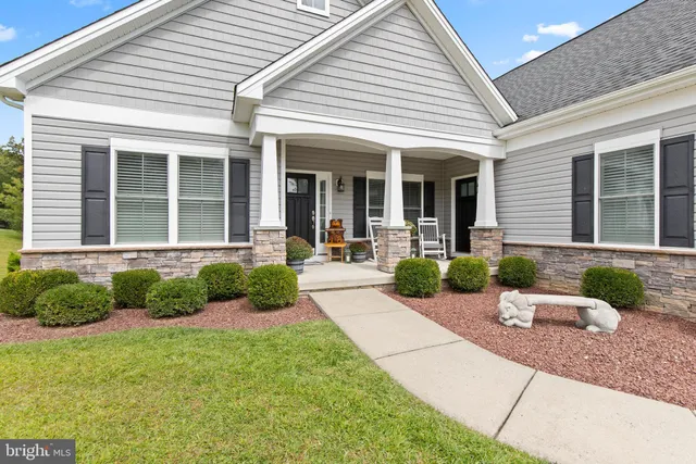 an aerial view of a house with swimming pool and patio