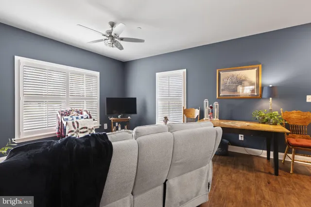 a view of a patio with table and chairs with plants and wooden fence