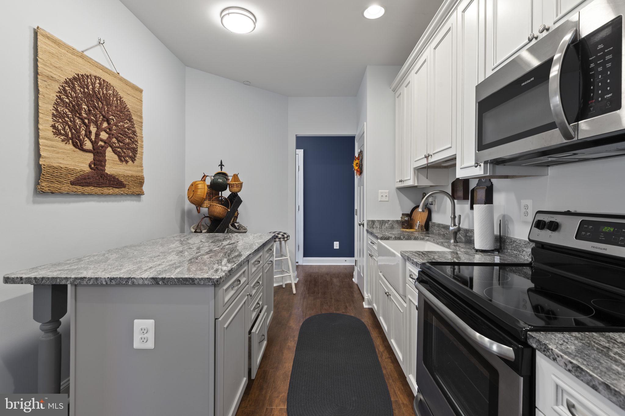 308 Rockspring Church Road Forest Hill, MD 21050 - Photo 44 of 79 a kitchen with stainless steel appliances granite countertop a sink stove and microwave