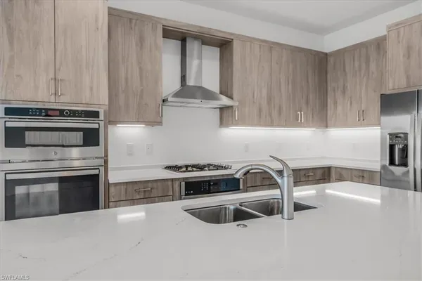 a kitchen with granite countertop a stove and a sink