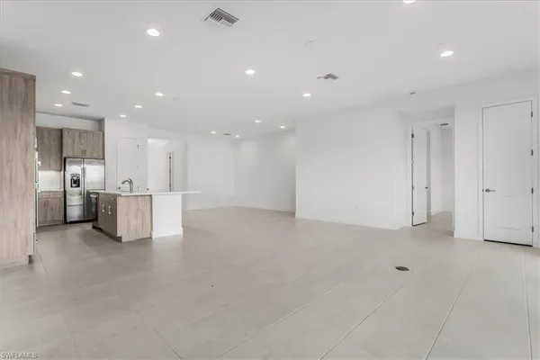 a large white kitchen with a large window