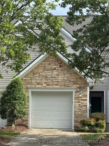 a front view of a house with garage