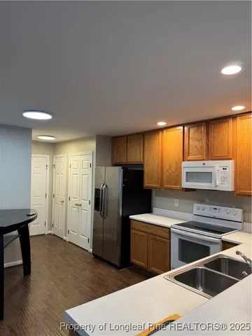 a kitchen with a refrigerator sink and cabinets