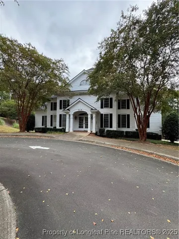 a front view of a house with a road