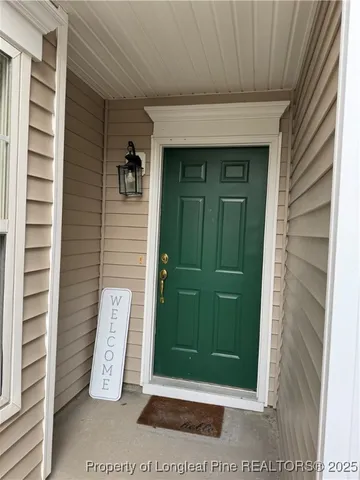 a front view of a house with a green gate