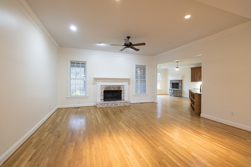 149 Allenhurst Circle Franklin, TN 37067 - Photo 11 of 44 an empty room with wooden floor fireplace and windows
