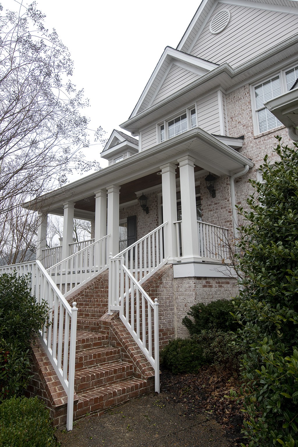 149 Allenhurst Circle Franklin, TN 37067 - Photo 43 of 44 a view of a white house with large windows and a small yard