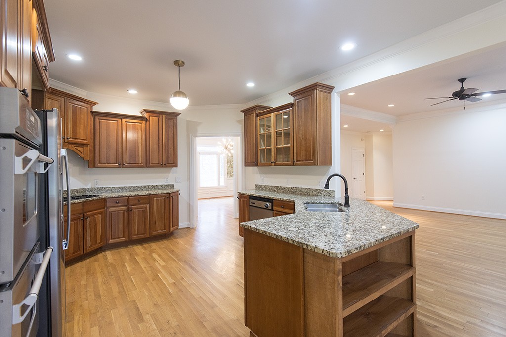 149 Allenhurst Circle Franklin, TN 37067 - Photo 9 of 44 a kitchen with kitchen island granite countertop wooden cabinets and refrigerator