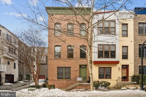 a view of a house with wooden fence