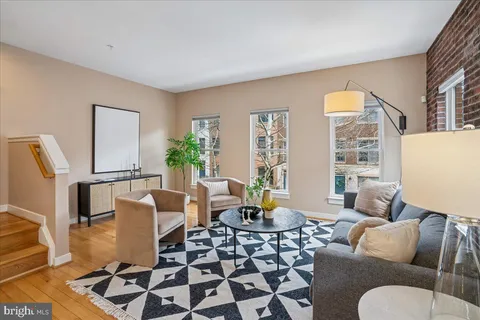 a living room with furniture kitchen view and a table