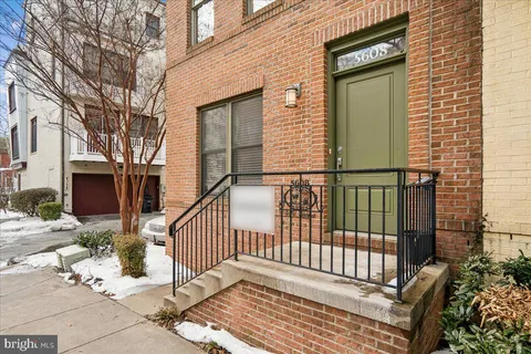 a view of a hallway with wooden floor and a potted plant