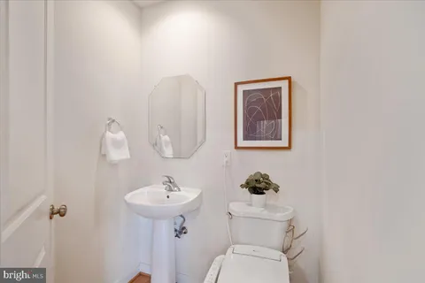 a bedroom with a bed wooden floor and window