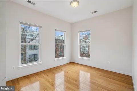 a living room with furniture rug and lamp