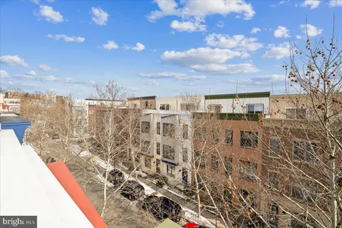 a view of a garden with a building in the background