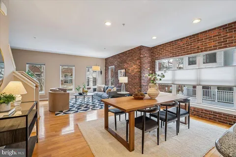 a dining room with furniture and wooden floor