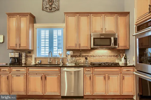 a dining room with wooden floor a chandelier a glass table and chairs