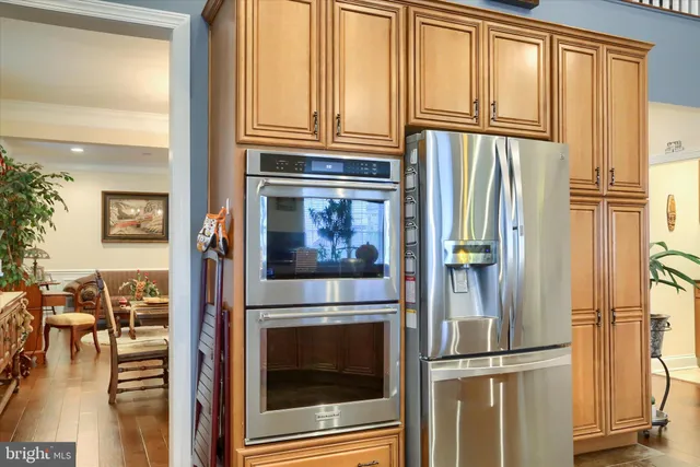 a living room with furniture kitchen view and a large window