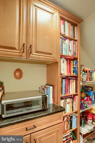 a view of a chair and table in backyard of the house