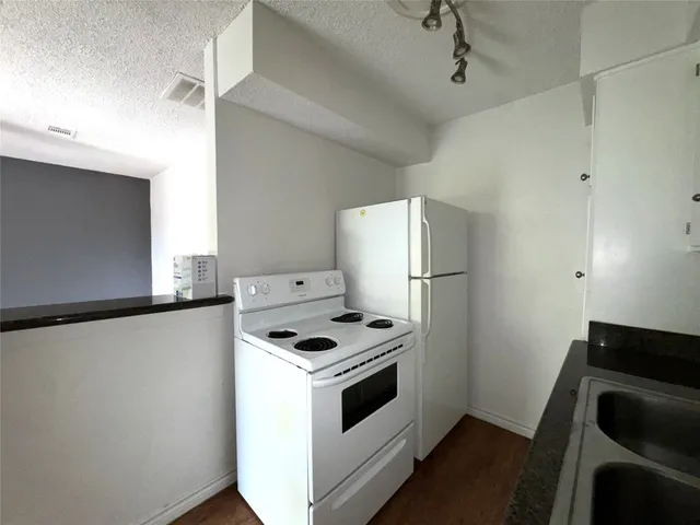 a kitchen with a stove and a refrigerator