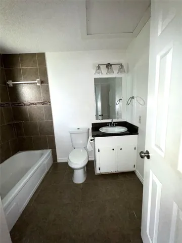 a bathroom with a toilet a sink and bathtub