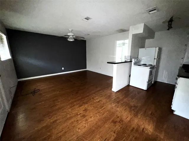 a view of a room with wooden floor and cabinet
