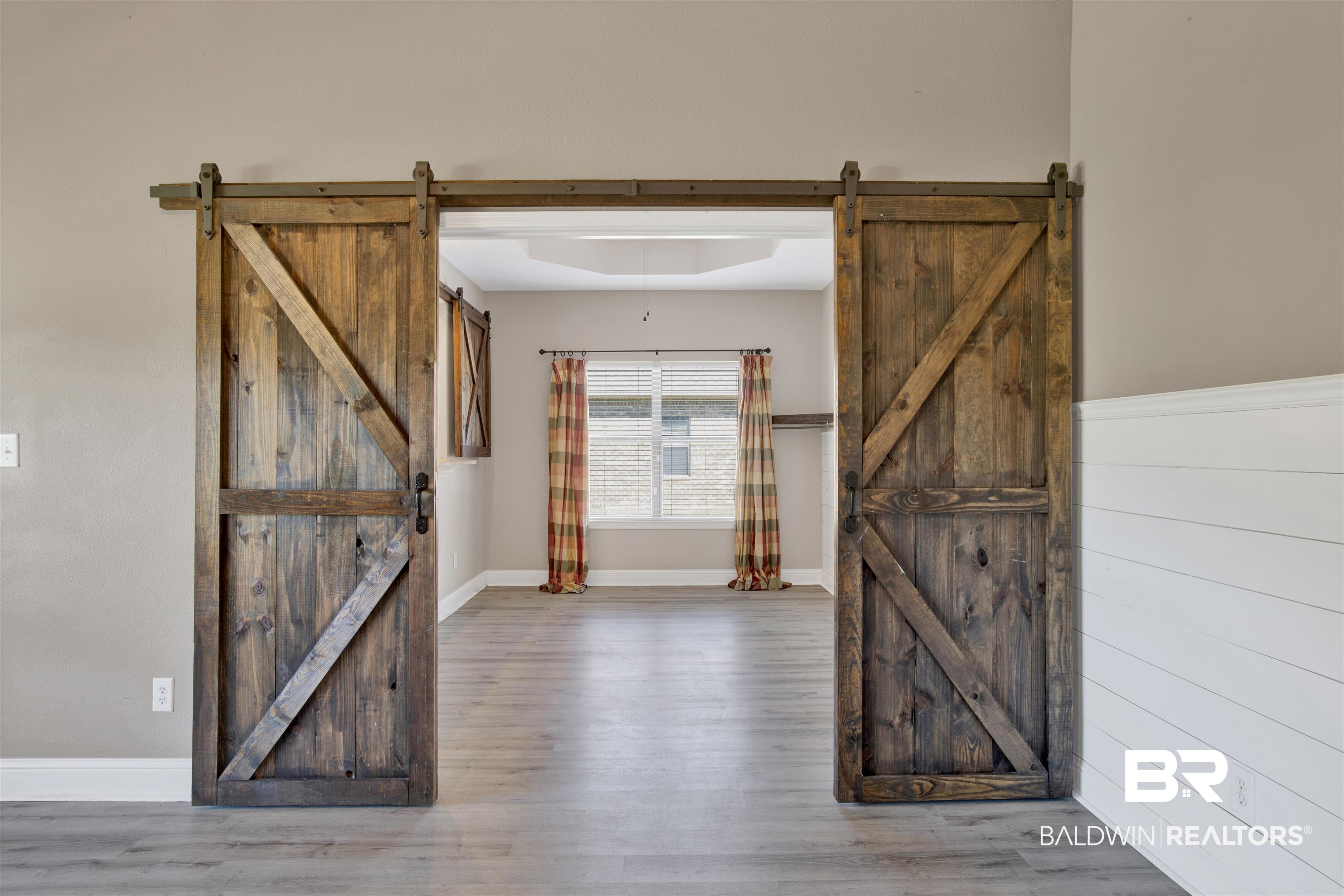 24159 Tullamore Drive Daphne, AL 36526 - Photo 8 of 31 Entryway featuring hardwood / wood-style floors, a barn door, a raised ceiling, and wood walls