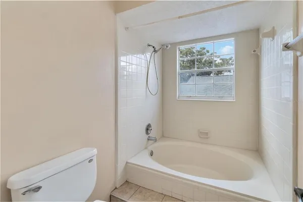 a white bath tub sitting next to a toilet