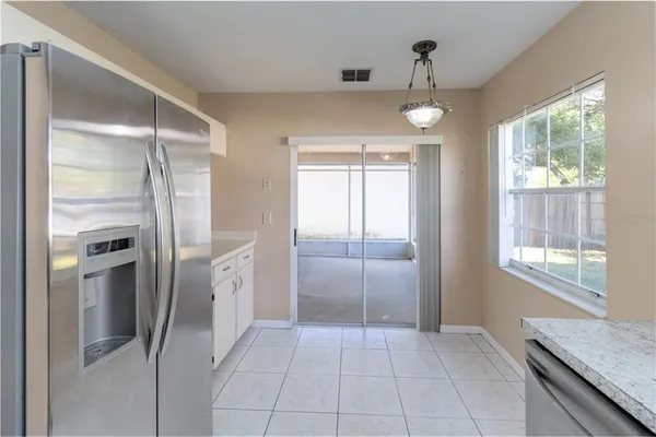 a view of a kitchen with a sink and refrigerator