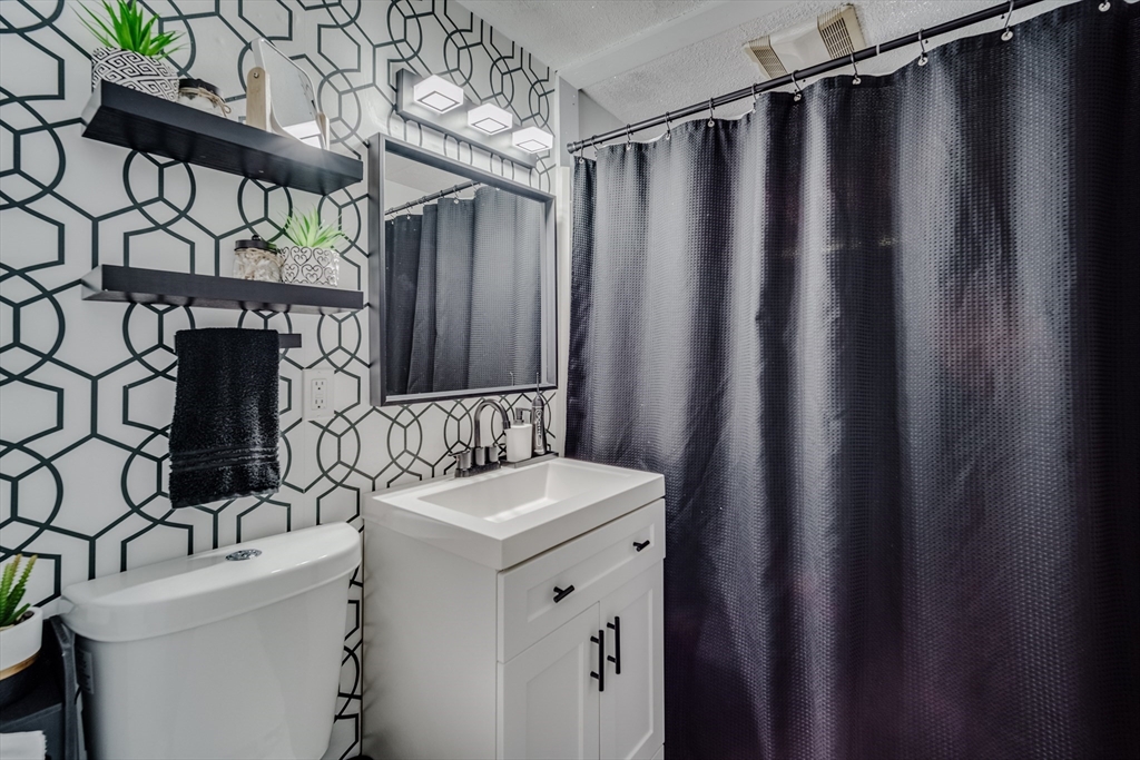 26 Groton Street Springfield, MA 01129 - Photo 12 of 24 a bathroom with a sink and a mirror