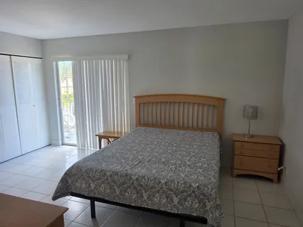 a bedroom with a bed and window