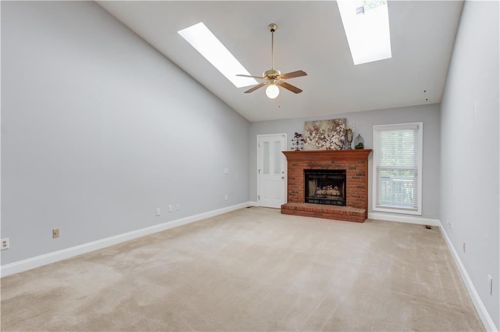 3220 Governors Court Duluth, GA 30096 - Photo 11 of 48 an empty room with fireplace and a window