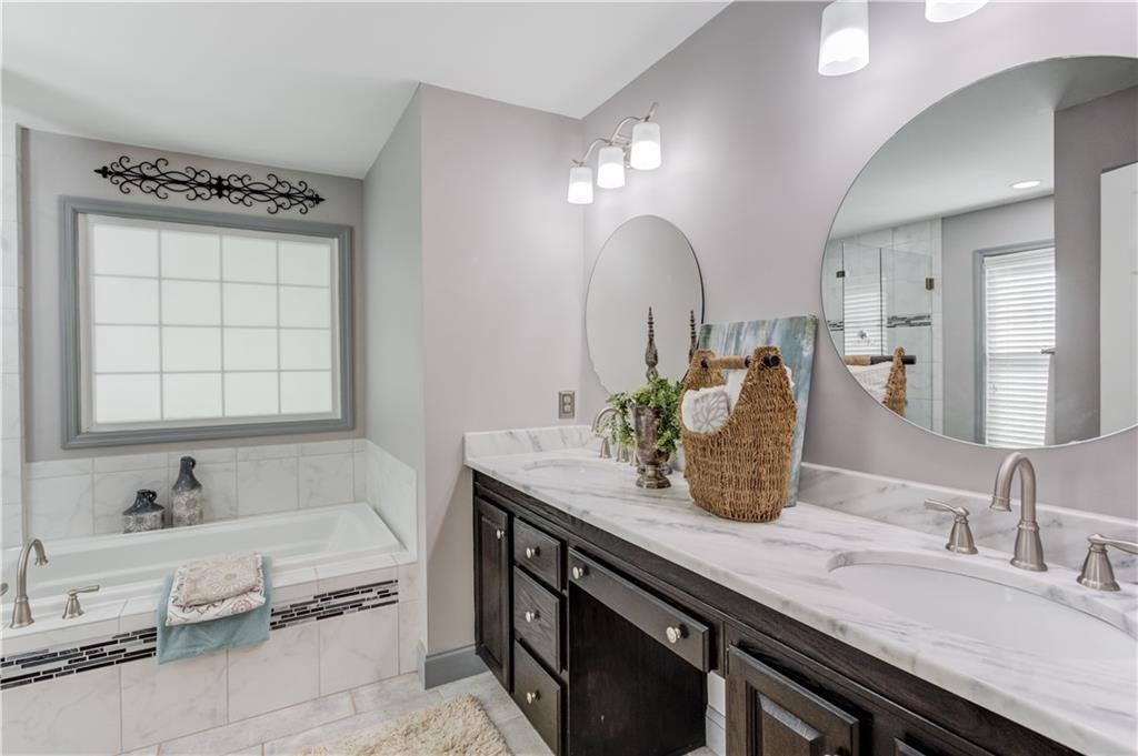 3220 Governors Court Duluth, GA 30096 - Photo 22 of 48 a bathroom with a granite countertop sink a large mirror and vanity