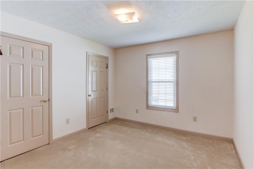 3220 Governors Court Duluth, GA 30096 - Photo 28 of 48 an empty room with closet and windows