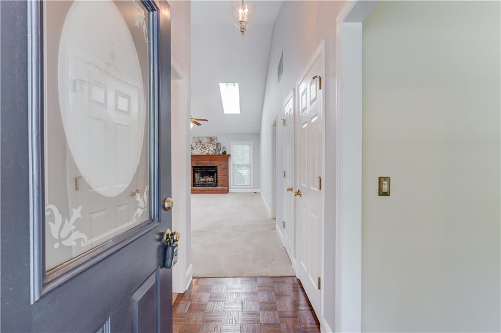 3220 Governors Court Duluth, GA 30096 - Photo 5 of 48 a view of a hallway with wooden floor and a livingroom