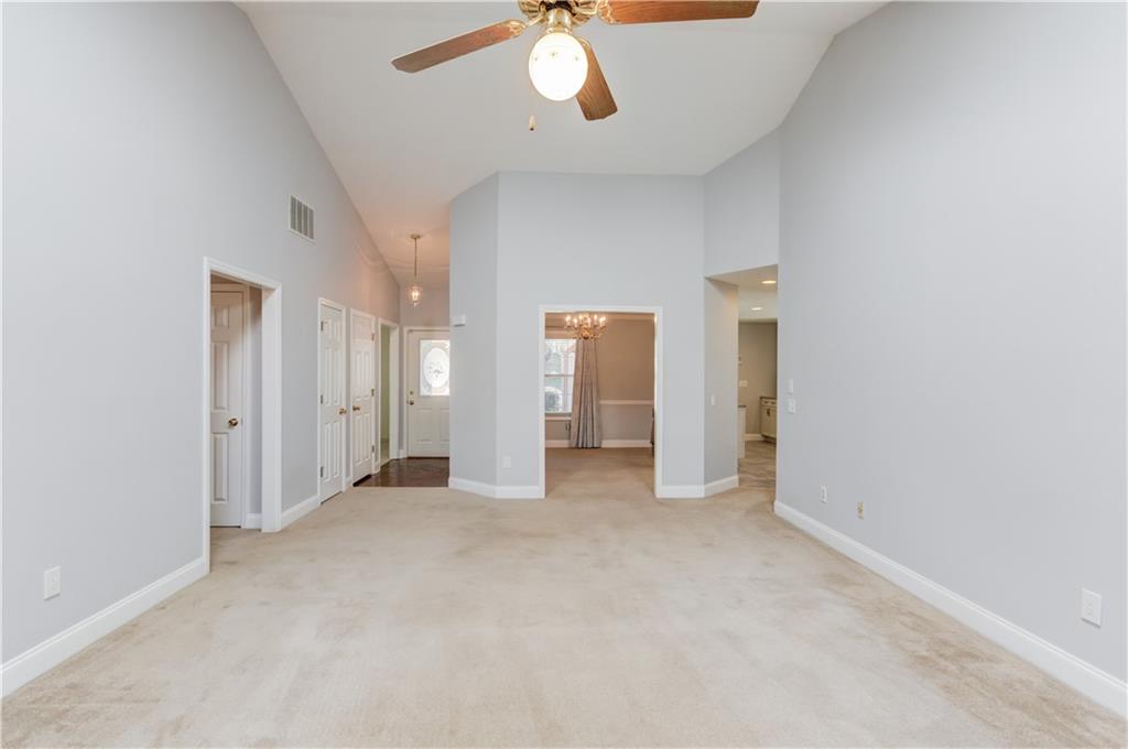 3220 Governors Court Duluth, GA 30096 - Photo 10 of 48 an empty room with chandelier fan and windows