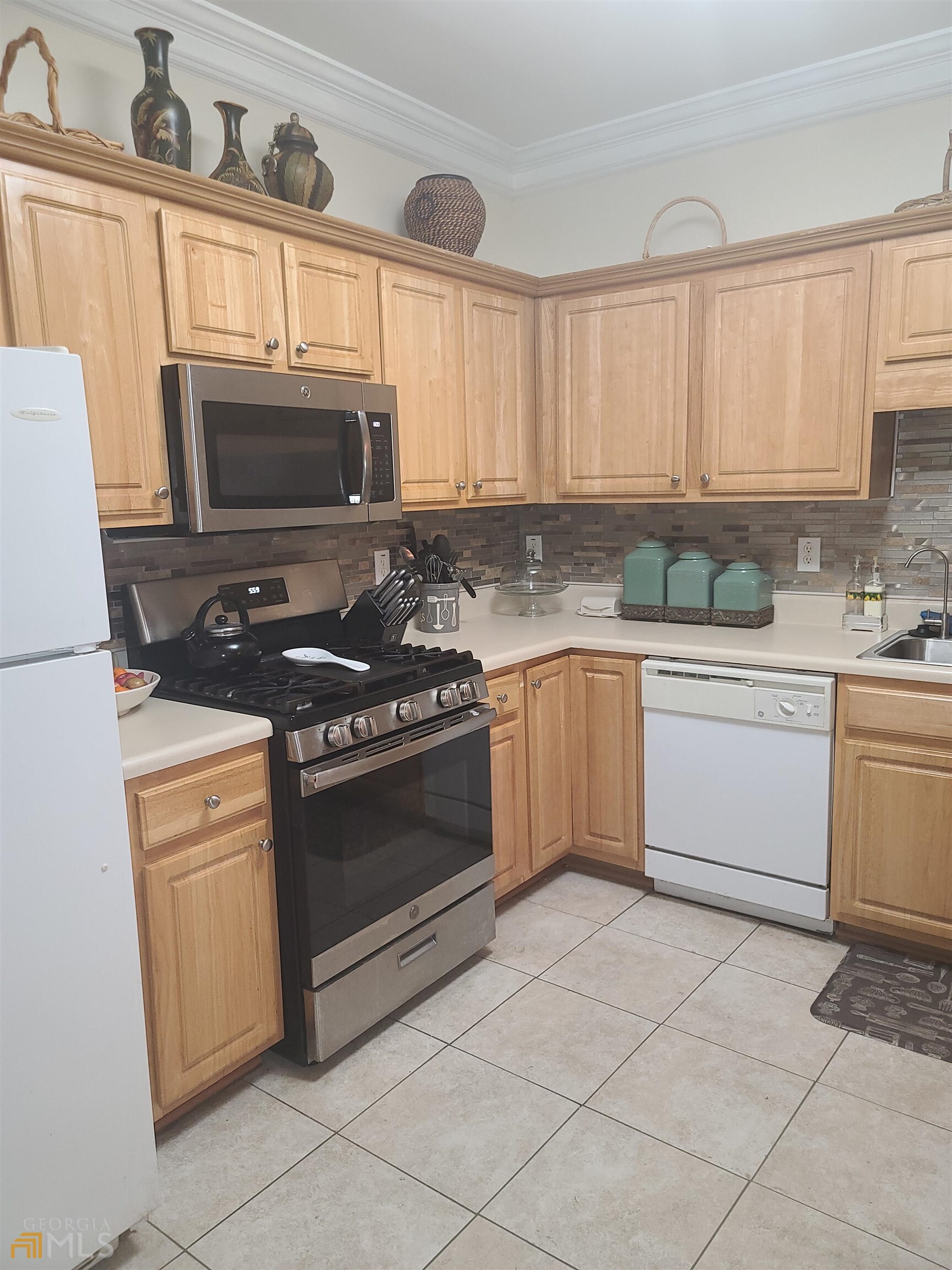 4857 Shae Court Powder Springs, GA 30127 - Photo 11 of 21 a kitchen with a stove sink and cabinets