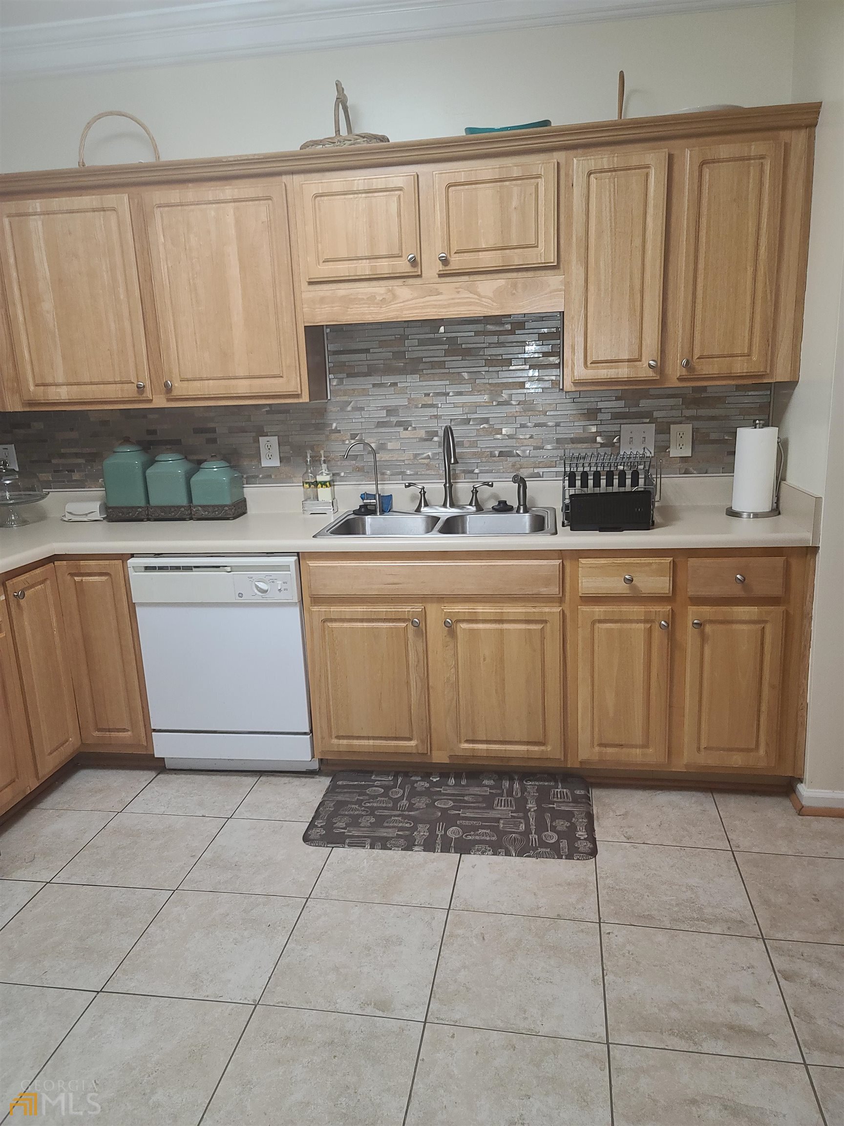 4857 Shae Court Powder Springs, GA 30127 - Photo 12 of 21 a kitchen with stainless steel appliances granite countertop a sink and cabinets