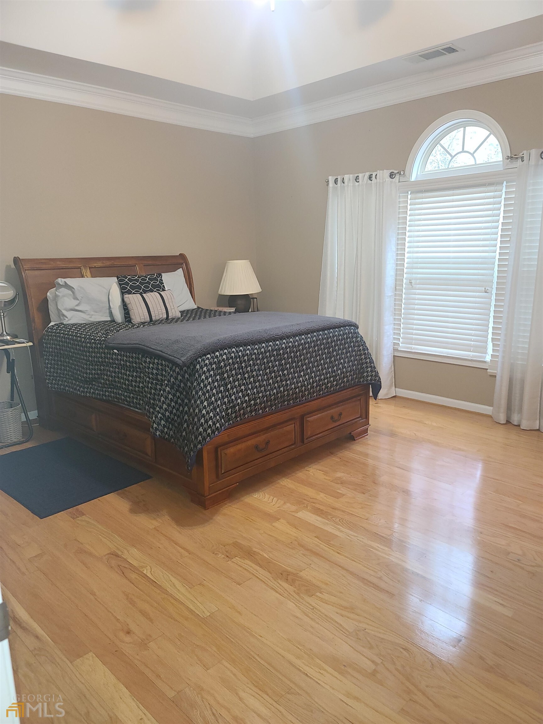 4857 Shae Court Powder Springs, GA 30127 - Photo 15 of 21 a spacious bedroom with a bed and wooden floor