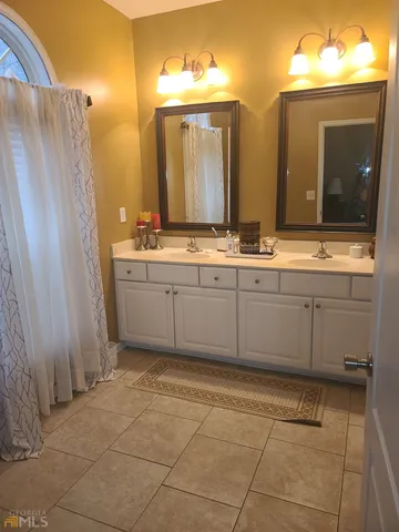 a bathroom with a granite countertop sink a mirror and a