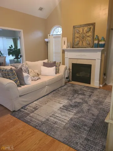 a living room with furniture and a fireplace