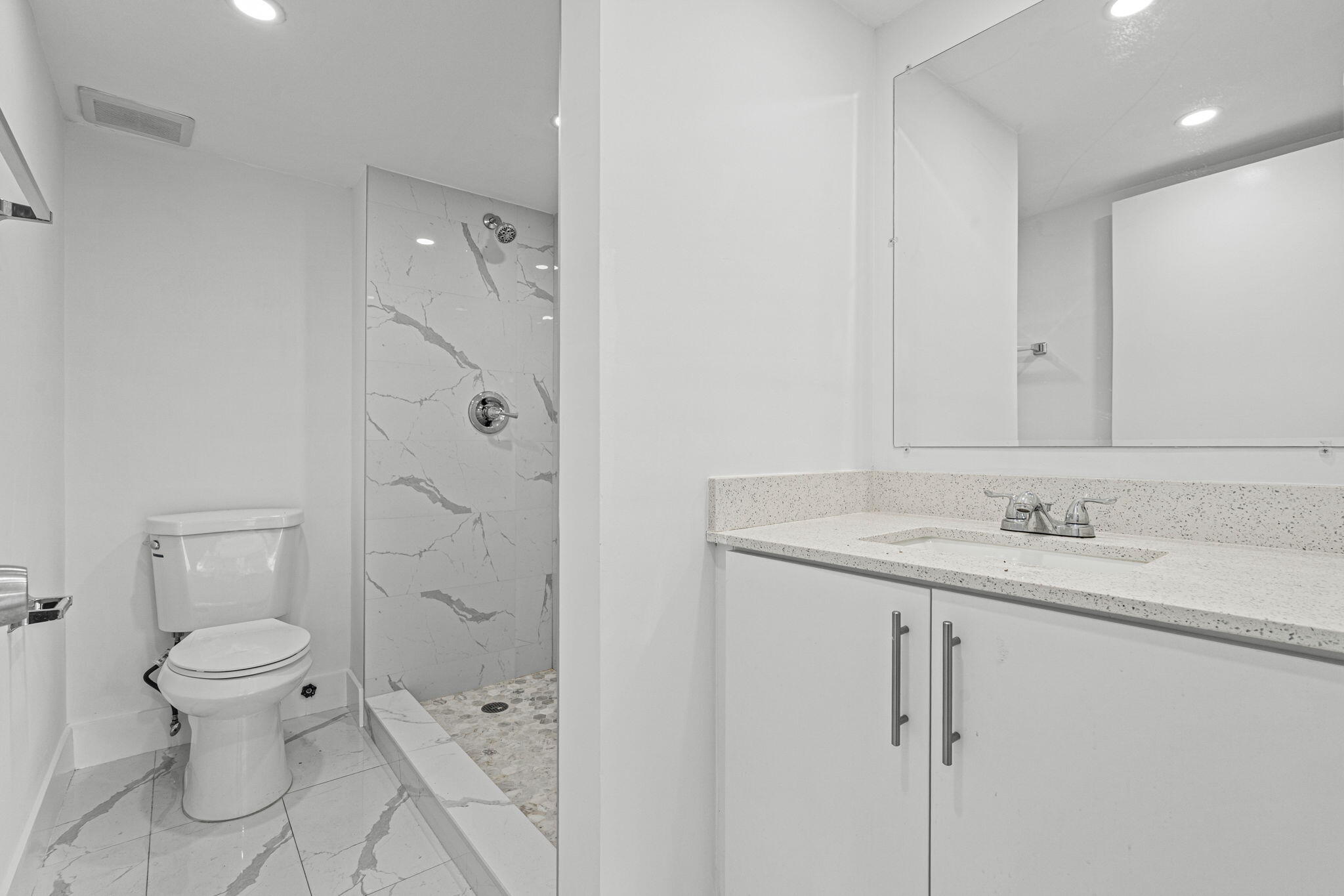 9227 Southwest 87th Avenue, Unit B1 Miami, FL 33176 - Photo 2 of 27 a bathroom with a granite countertop sink a toilet and shower