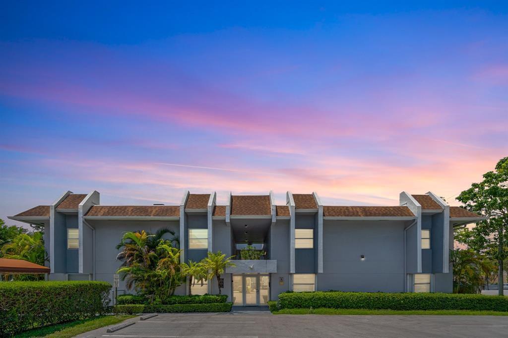 9227 Southwest 87th Avenue, Unit B1 Miami, FL 33176 - Photo 26 of 27 a view of a residential apartment building with a yard