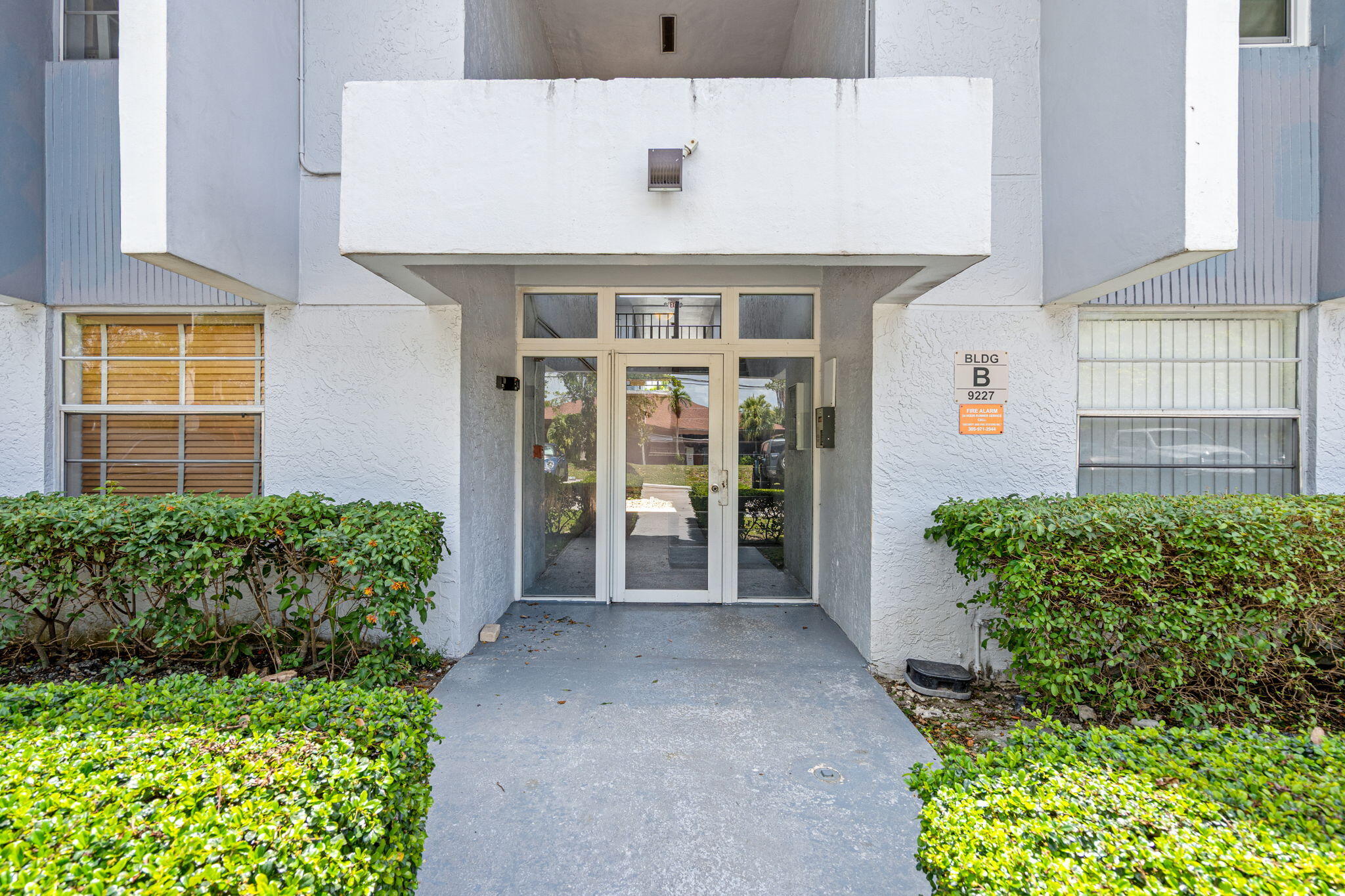 9227 Southwest 87th Avenue, Unit B1 Miami, FL 33176 - Photo 6 of 27 a front view of a house with a yard