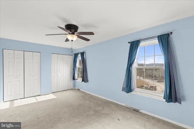 a view of room with a ceiling fan and window