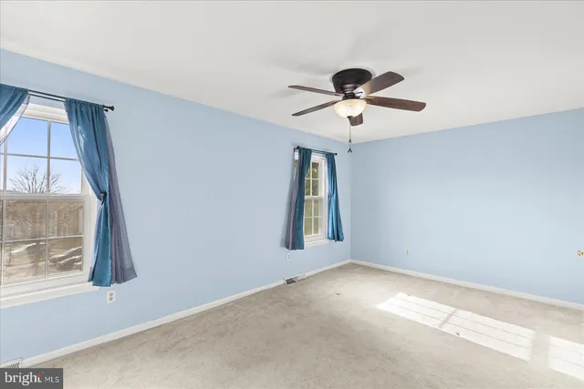 a view of room with window and ceiling fan
