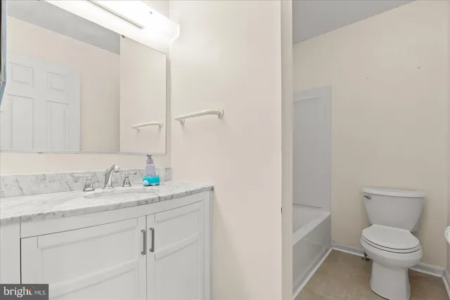 a bathroom with a sink toilet and mirror
