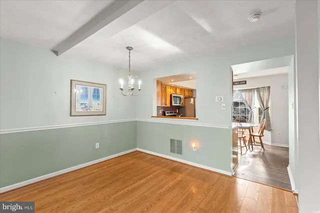 a view of a room with wooden floor and a window