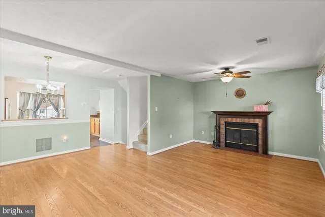 a view of an empty room with window and fireplace