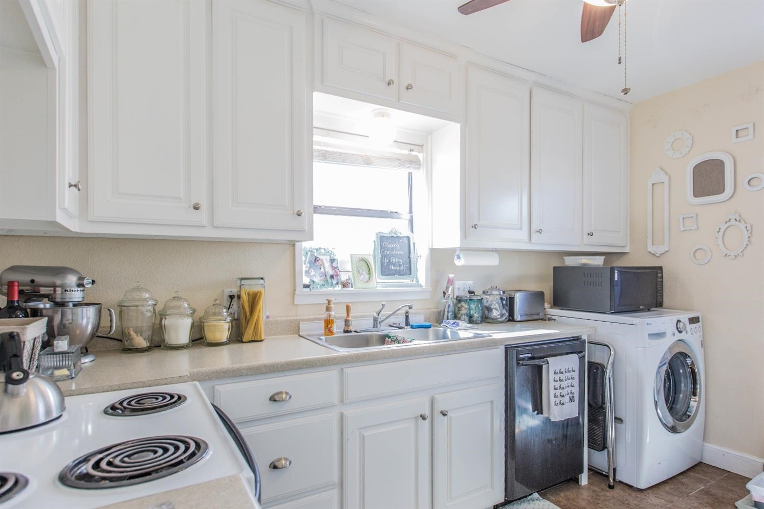 2806 30th Street Lubbock, TX 79410 - Photo 6 of 10 a kitchen with a sink a stove and cabinets