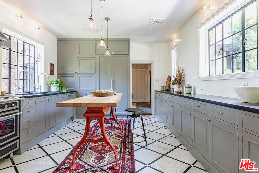 3701 Shannon Road Los Angeles, CA 90027 - Photo 11 of 54 a kitchen with stainless steel appliances kitchen island granite countertop a sink and a granite counter tops